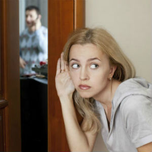 Houston private investigator case solved photo of woman listening behind door