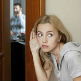 Woman listening to a private investigator on the phone.